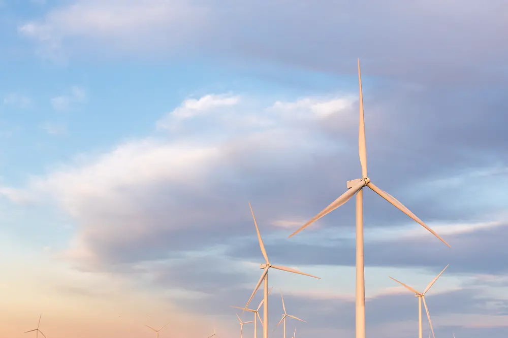 Wind turbines of a wind farm with sky in the background