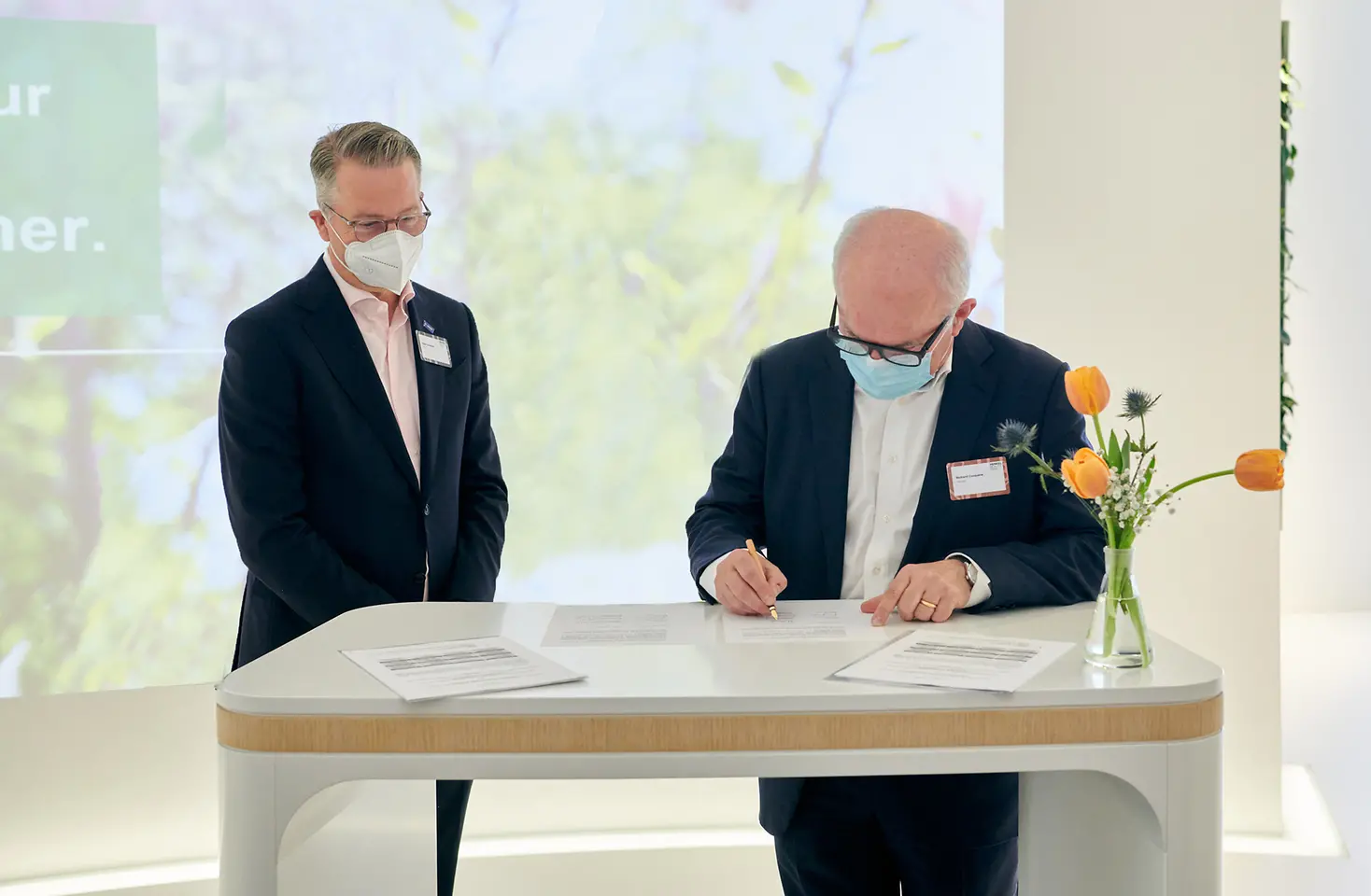 The two representatives of BASF and Henkel are signing the contract. 