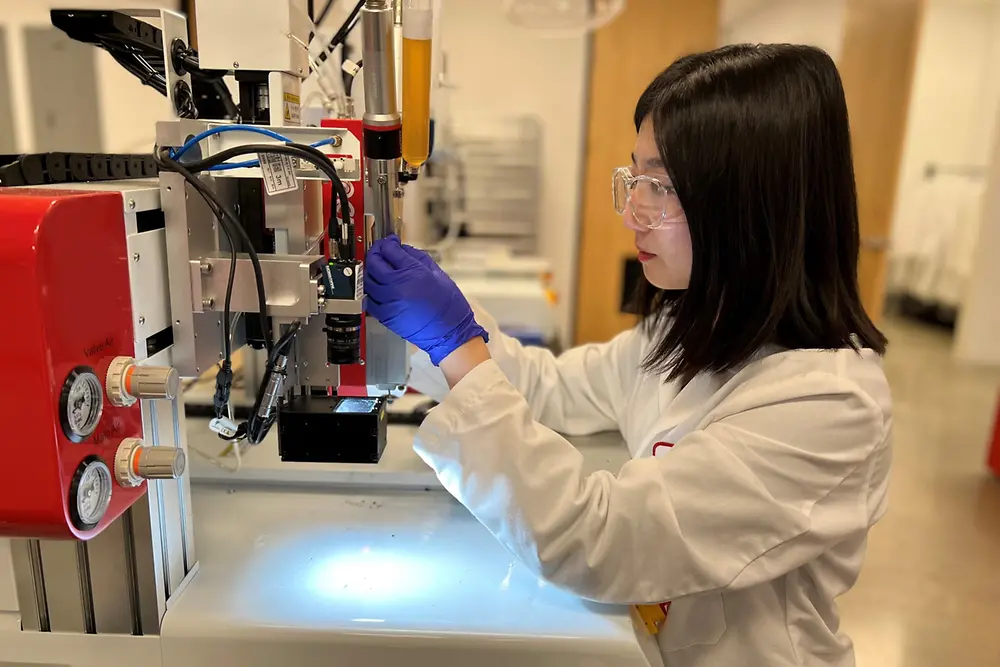 Henkel Associate Application Engineer Olivia Shin works on dispensing equipment