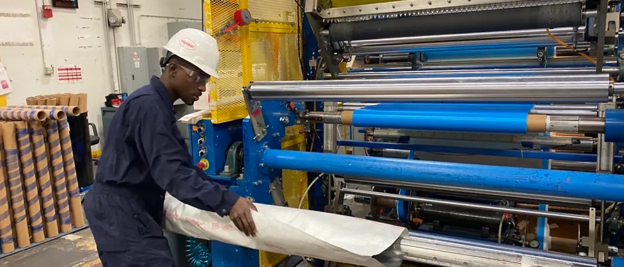 Man wrapping a roll of film 