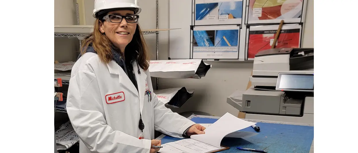 Woman in lab coat reviewing documents