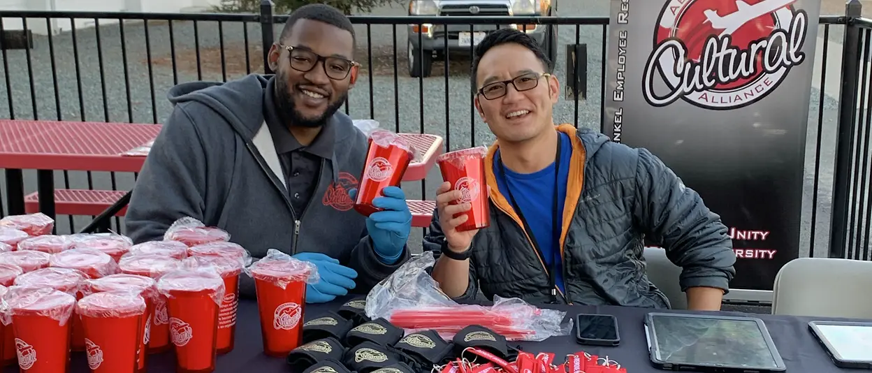 People staffing table with free merchandise