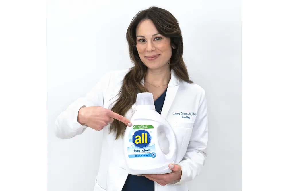 picture of Dr. Lindsey Zubritsky, doctor holding all bottle wearing a white lab coat