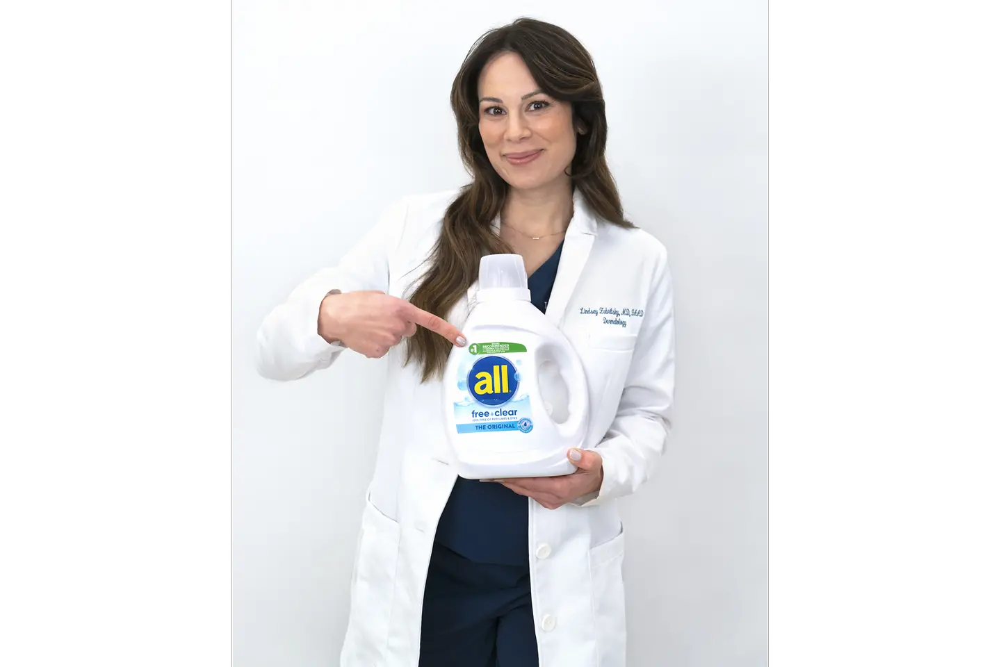 picture of Dr. Lindsey Zubritsky, doctor holding all bottle wearing a white lab coat