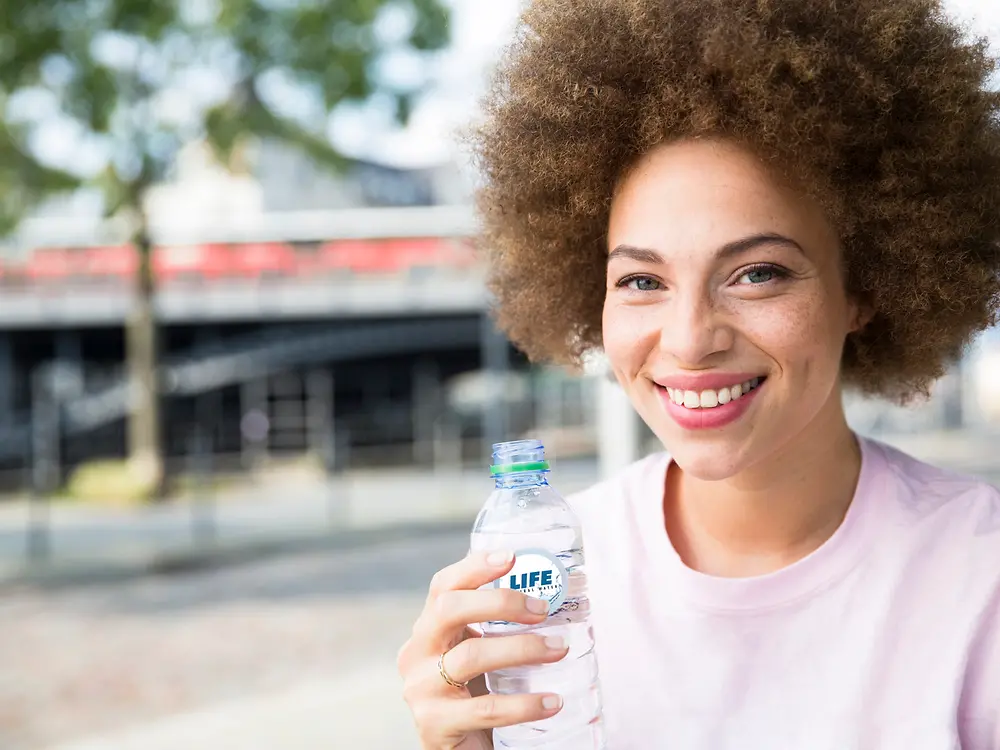 ai-positioning-aif-woman-with-pet-bottle-getty-675021107-high