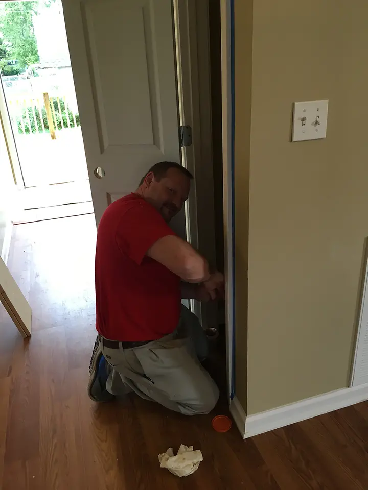 A Henkel employee puts the finishing touches on a closet for the Habitat for Humanity® home.