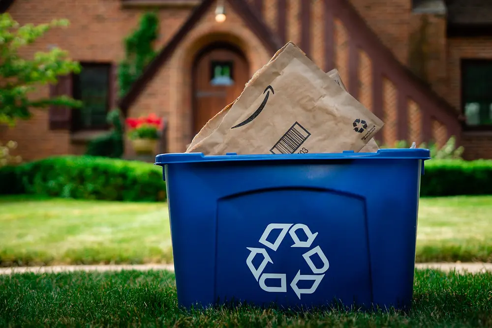 EPIX™ expands paper functionality and improves performance while maintaining the sustainability and recyclability of the package - a blue recycling bin with discarded paper envelopes